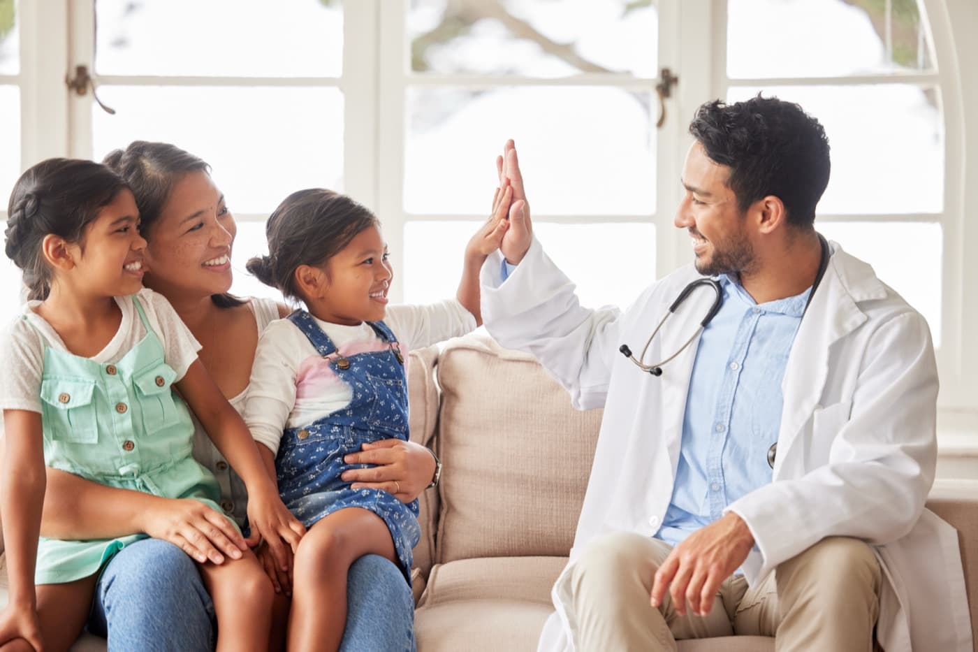 Allergist celebrating with a family during a consultation
